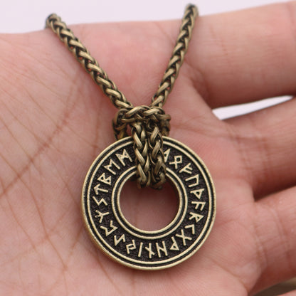 Rune coin amulet — aged bronze