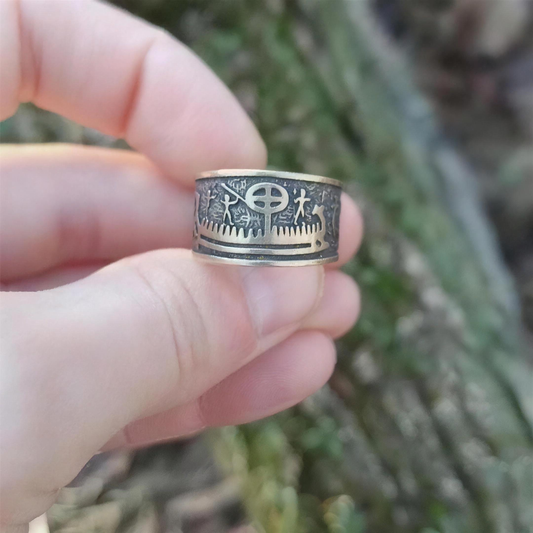 Viking Petroglyph Ring in stainless steel, sun wheel Norse symbol carved around the band, shown at an angle
